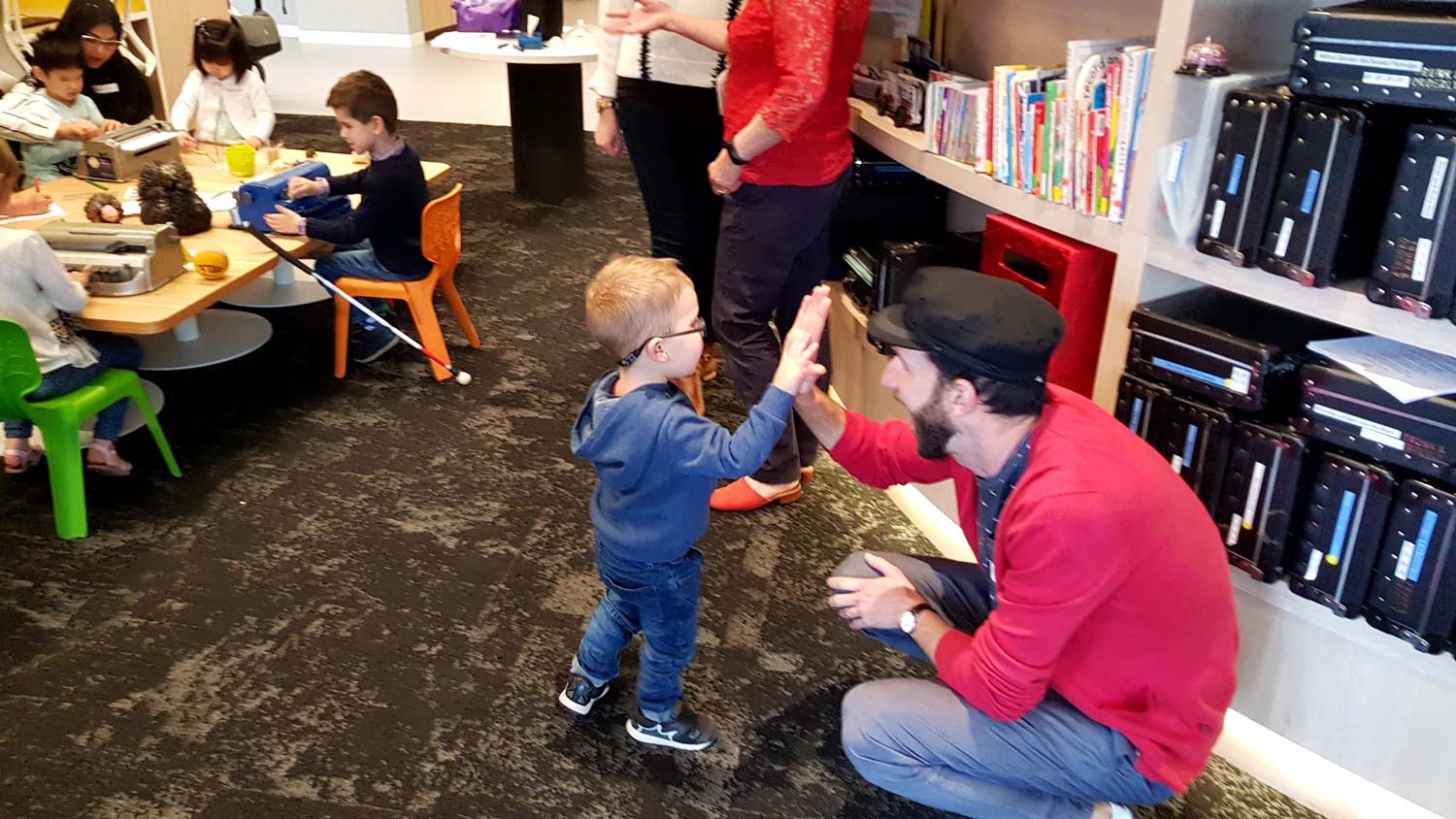 Matt does a high-five with one of the kids